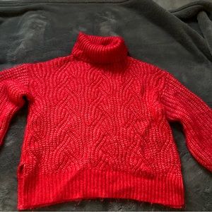 Red “A new day” knitted sweater.